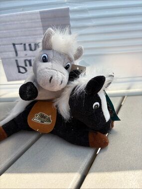 Kentucky Derby Plush race horses, one black-and-white one gray and white